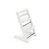 White adjustable wooden high chair with black footrest on white background. 
