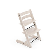 White wooden adjustable high chair with black accents on white background. 

