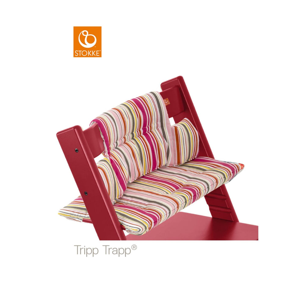 Red Stokke Tripp Trapp high chair featuring a colorful striped seat cushion and backrest for comfortable and stylish mealtimes. 
